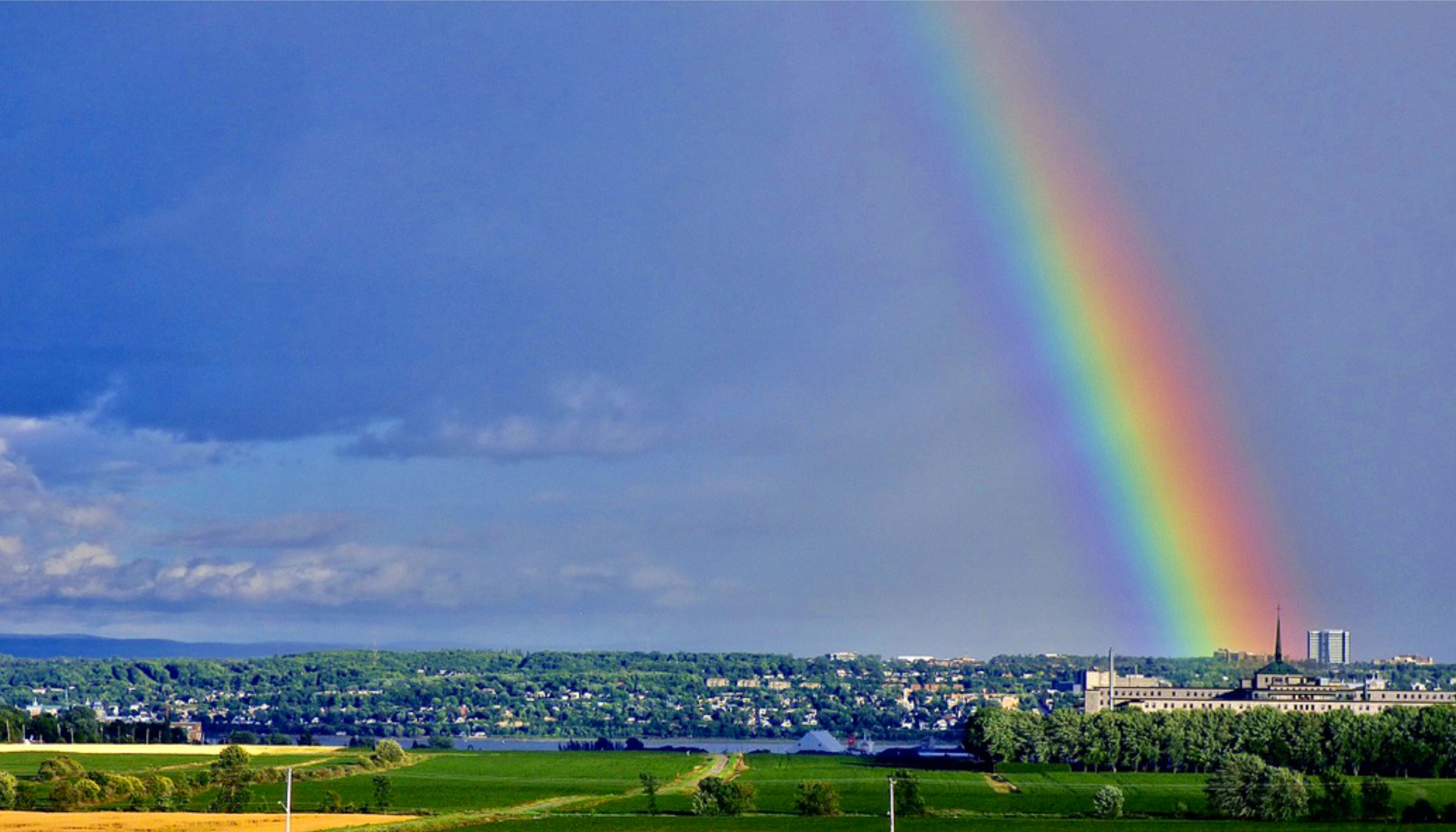 A Rainbow In The Sky Over A City